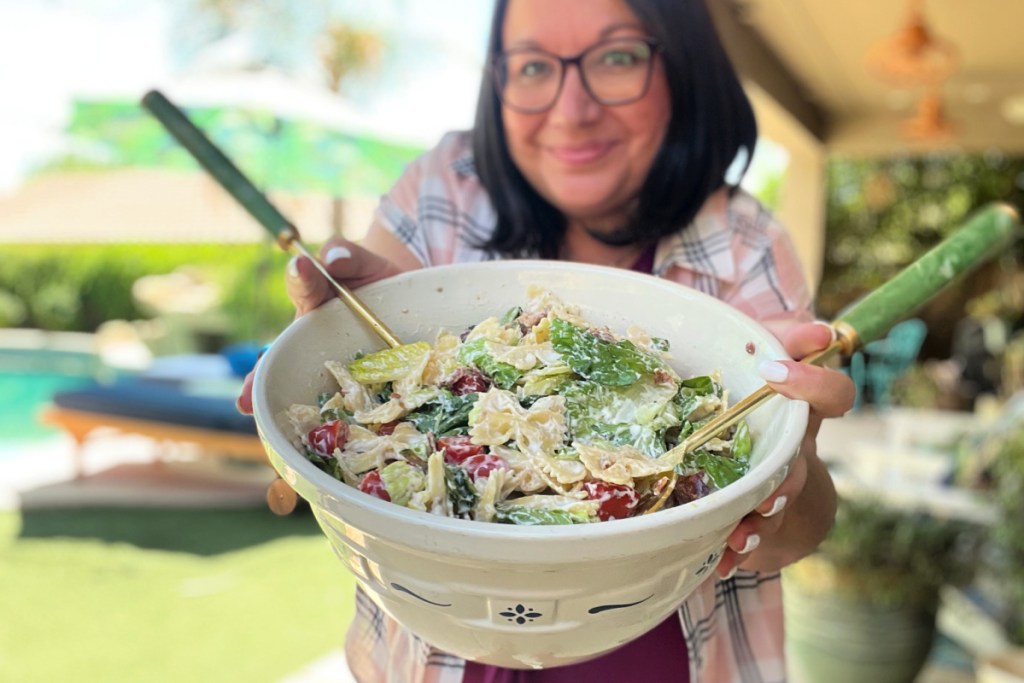 woman holding a large bowl of ranch blt salad