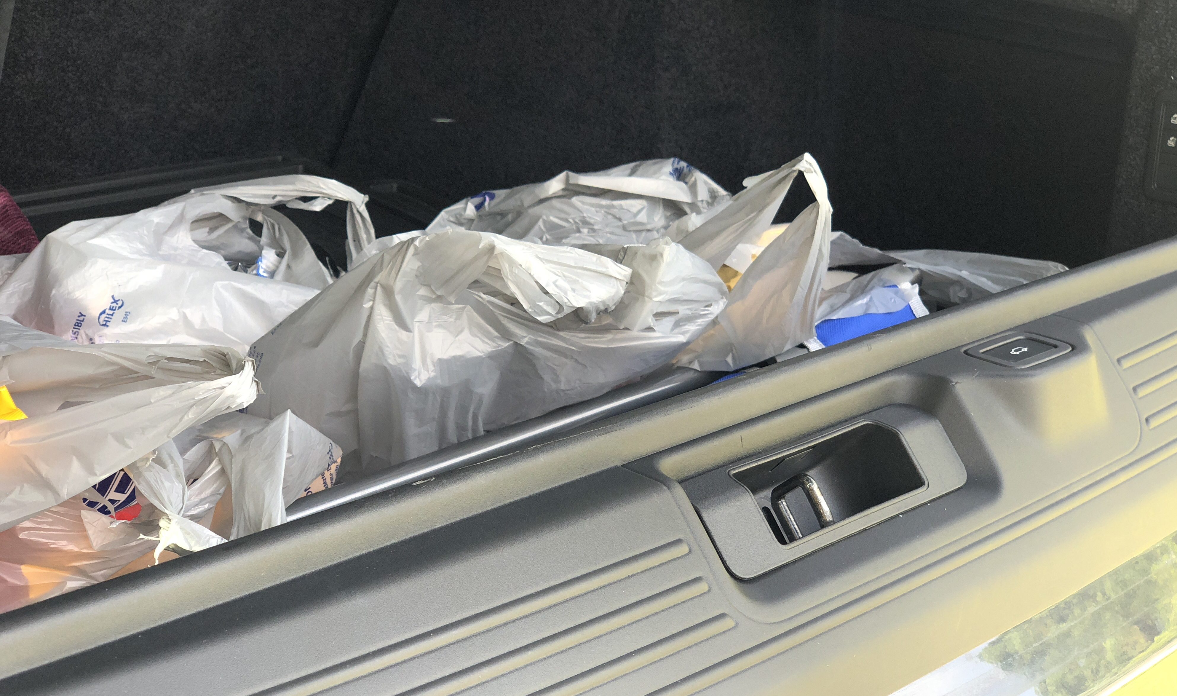 ALDI adds online grocery shopping delivery service – car trunk filled with grocery bags