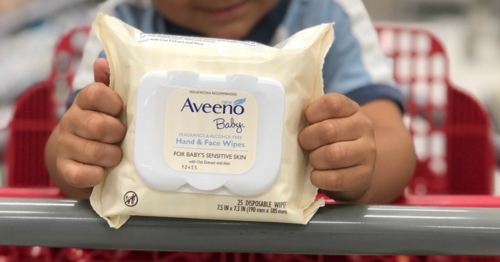boy holding Aveeno Baby Wipes