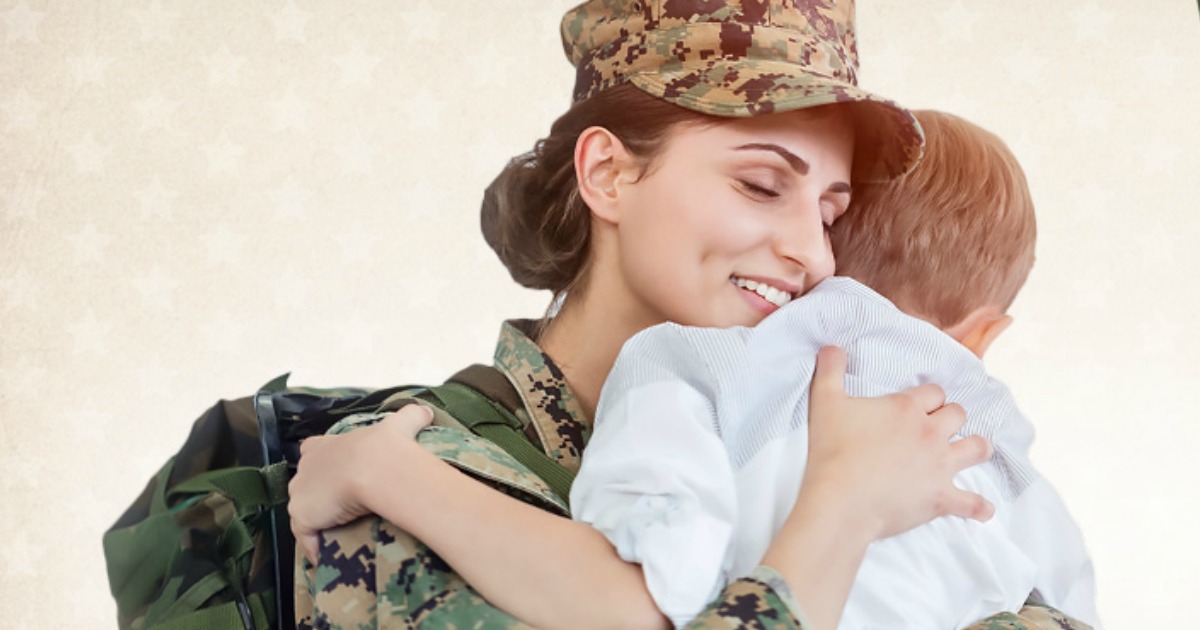 woman in uniform hugging child