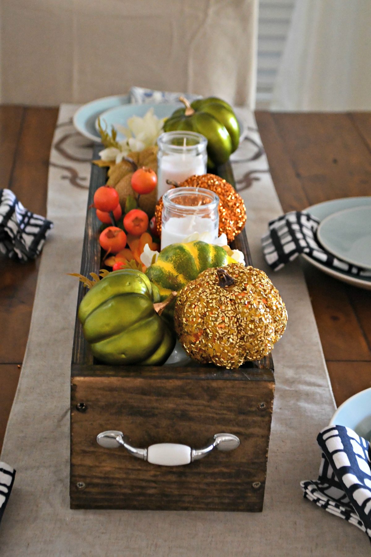 dollar tree fall centerpiece - one of my looks uses a fun assortment of pumpkins, greenery, and candles