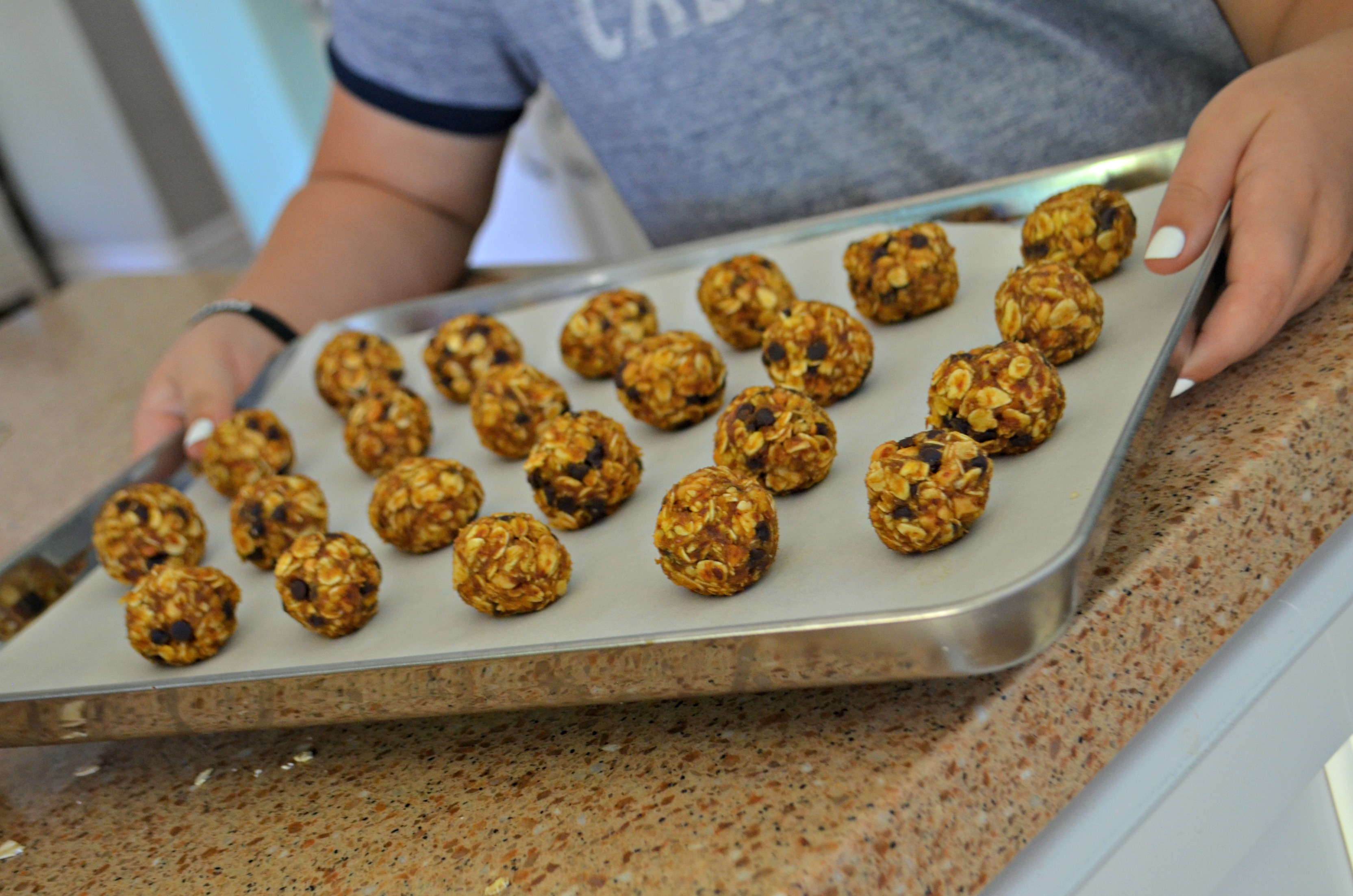 No-Bake Pumpkin Oatmeal Energy Bites rolled into balls on a baking sheet for cooling
