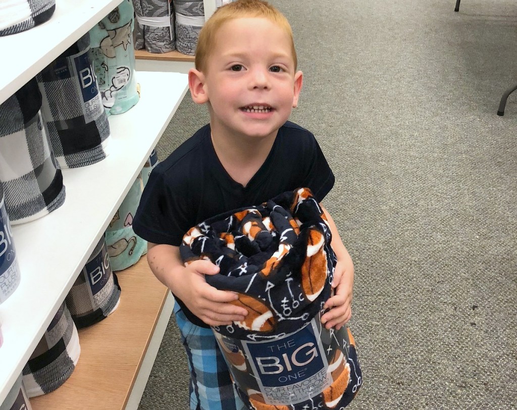 best blankets — erica's son holding his new The Big One blanket from Kohl's