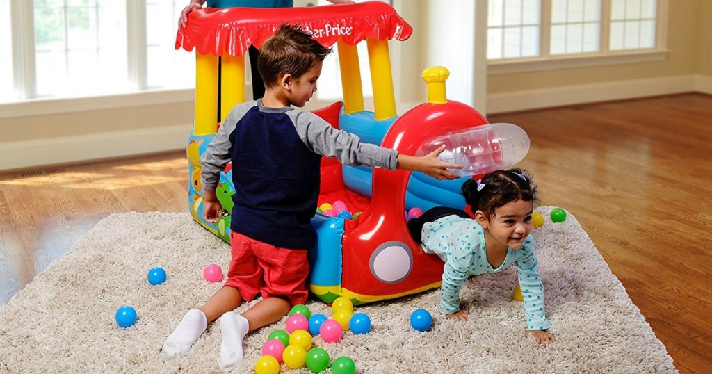 kids playing in an inflatable ball pit from fisher price 