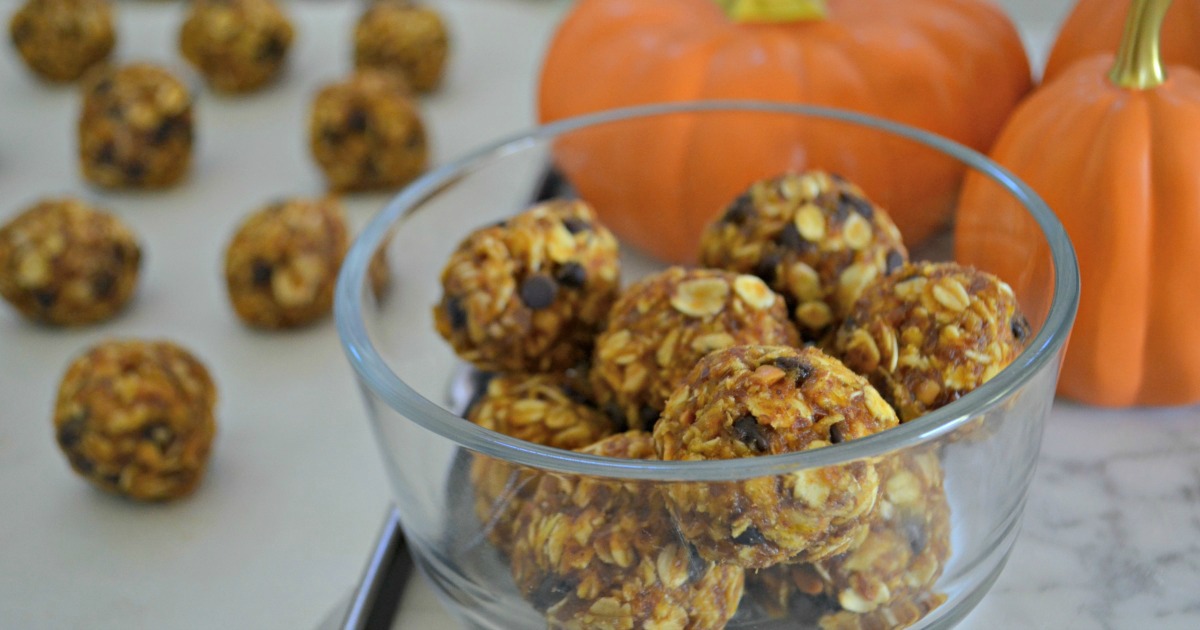 Pumpkin chocolate chip Oatmeal Cookie Dough Energy Bites – in a bowl next to pumpkins