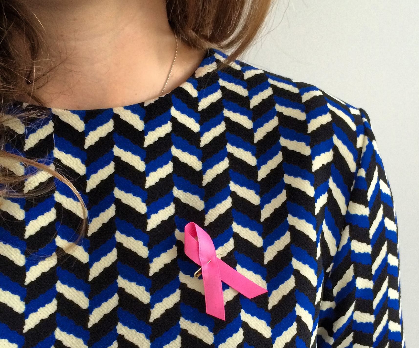 Breast Cancer Awareness Month: Mammograms, signs, ways to give back – woman wearing a pink ribbon