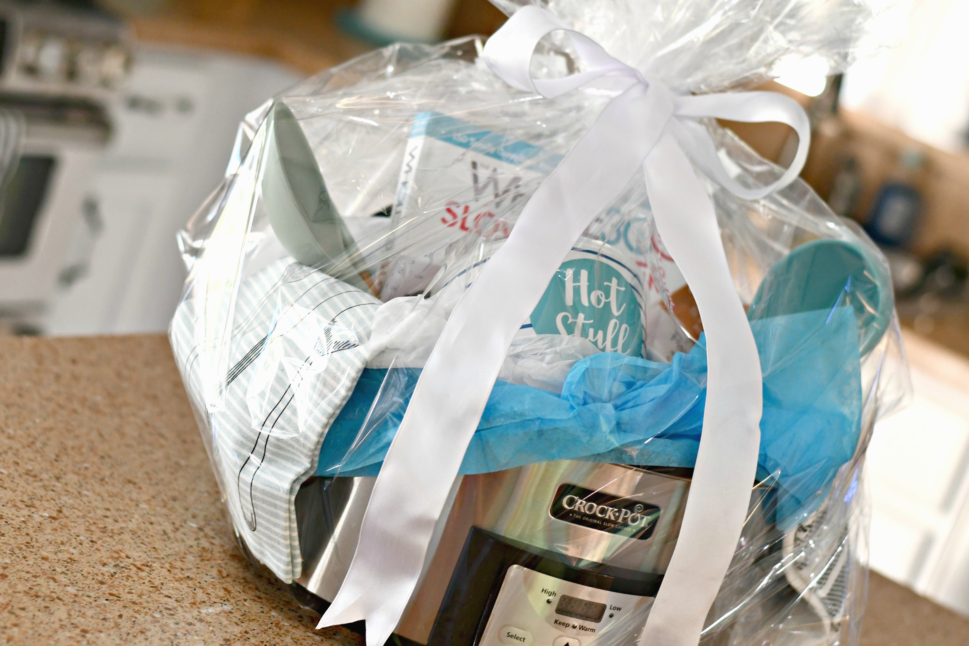 diy gift slow cooker gift basket – All wrapped with clear plastic and a bow