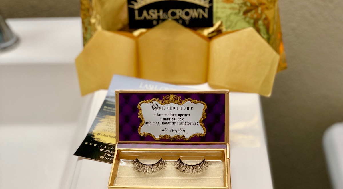 set of black false eyelashes in gold and purple box sitting on white countertop