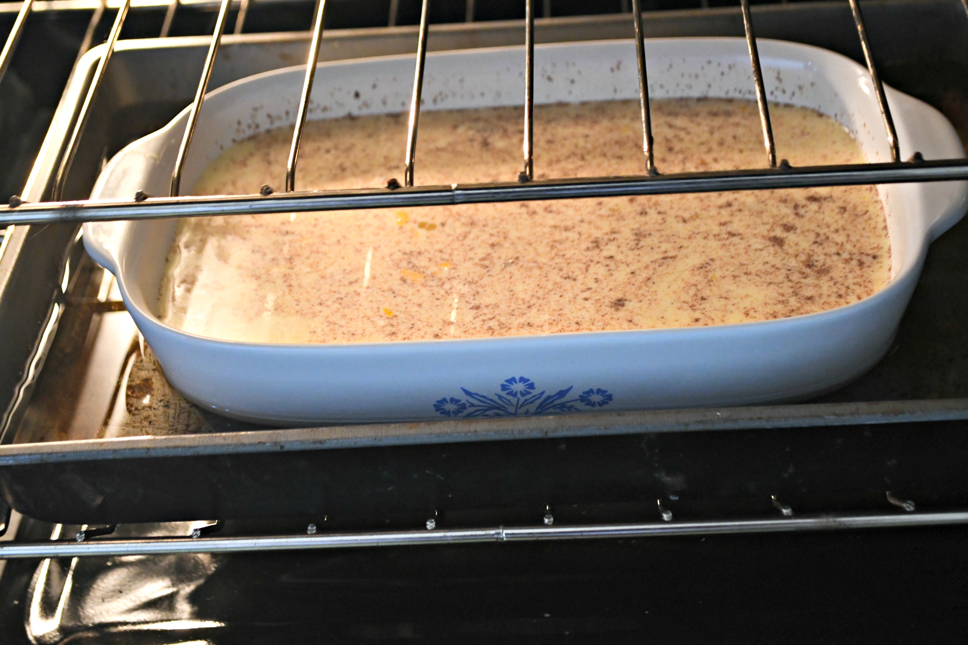 Classic Grape-Nuts Pudding in the oven in the pan of water