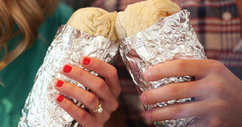 Chipotle Burritos in people's hands toasting