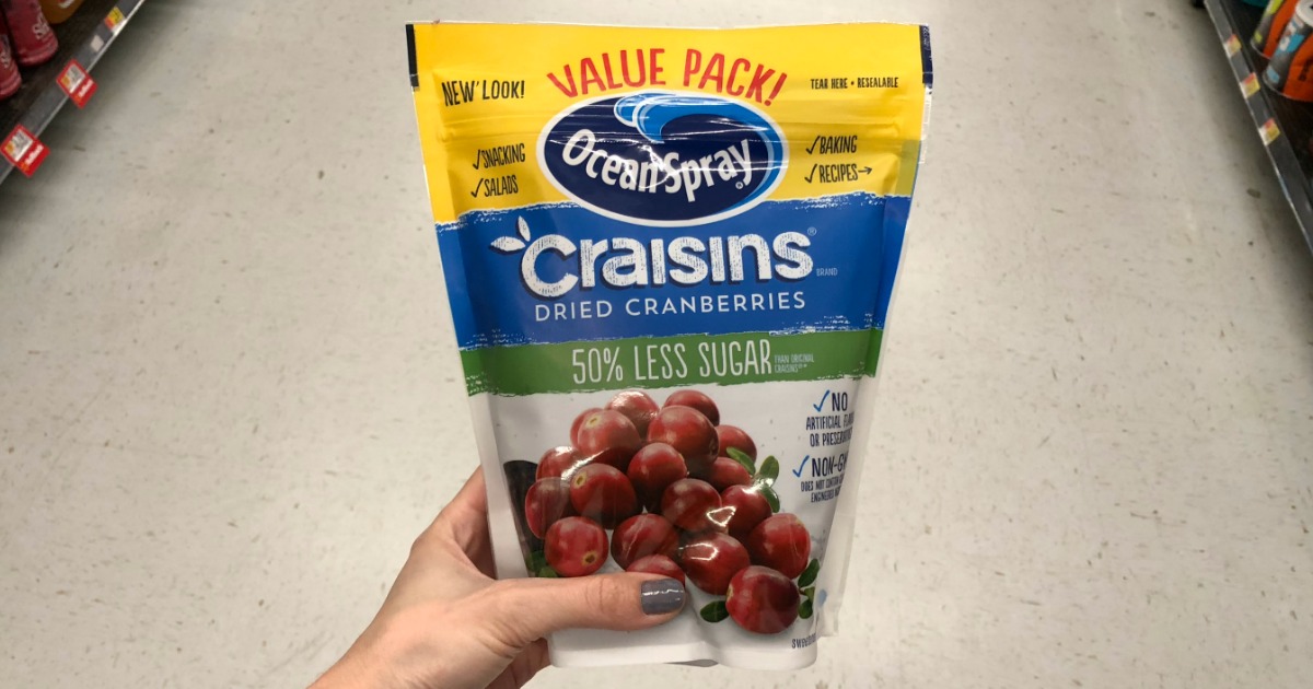 value pack of Ocean Spray Craisins dried cranberries 50% less sugar being held in a store
