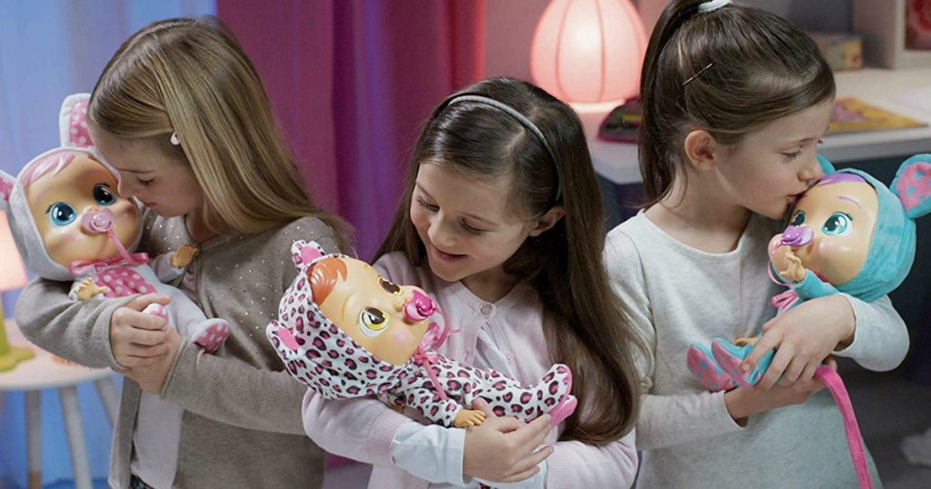 girls holding cry baby dolls