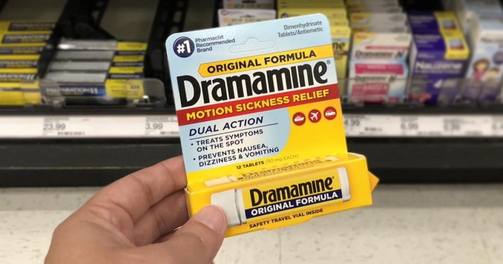 Hand holding up a package of dramamine