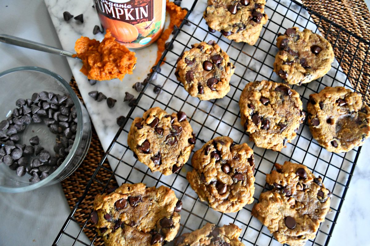 Pumpkin Chocolate Chip Cookies – on a cooling rack with pumpkin and chocolate chips nearby