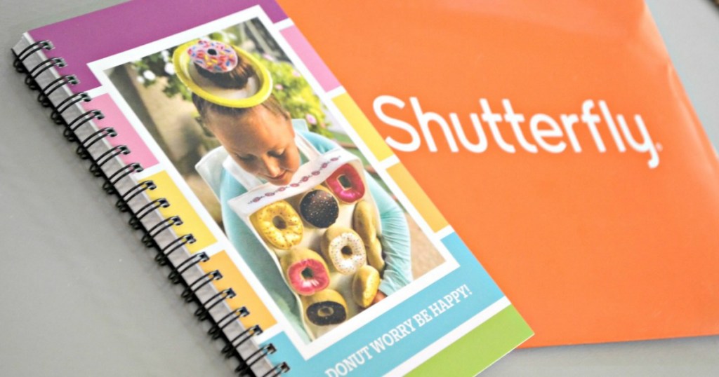 custom spiral-bound notebook next to Shuttefly envelope