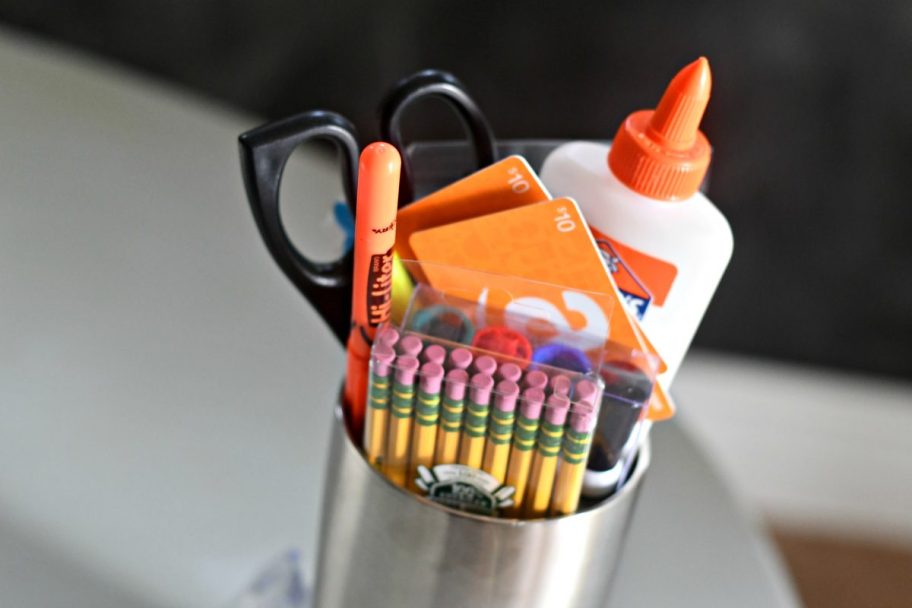 various school supplies in stainless steel cup