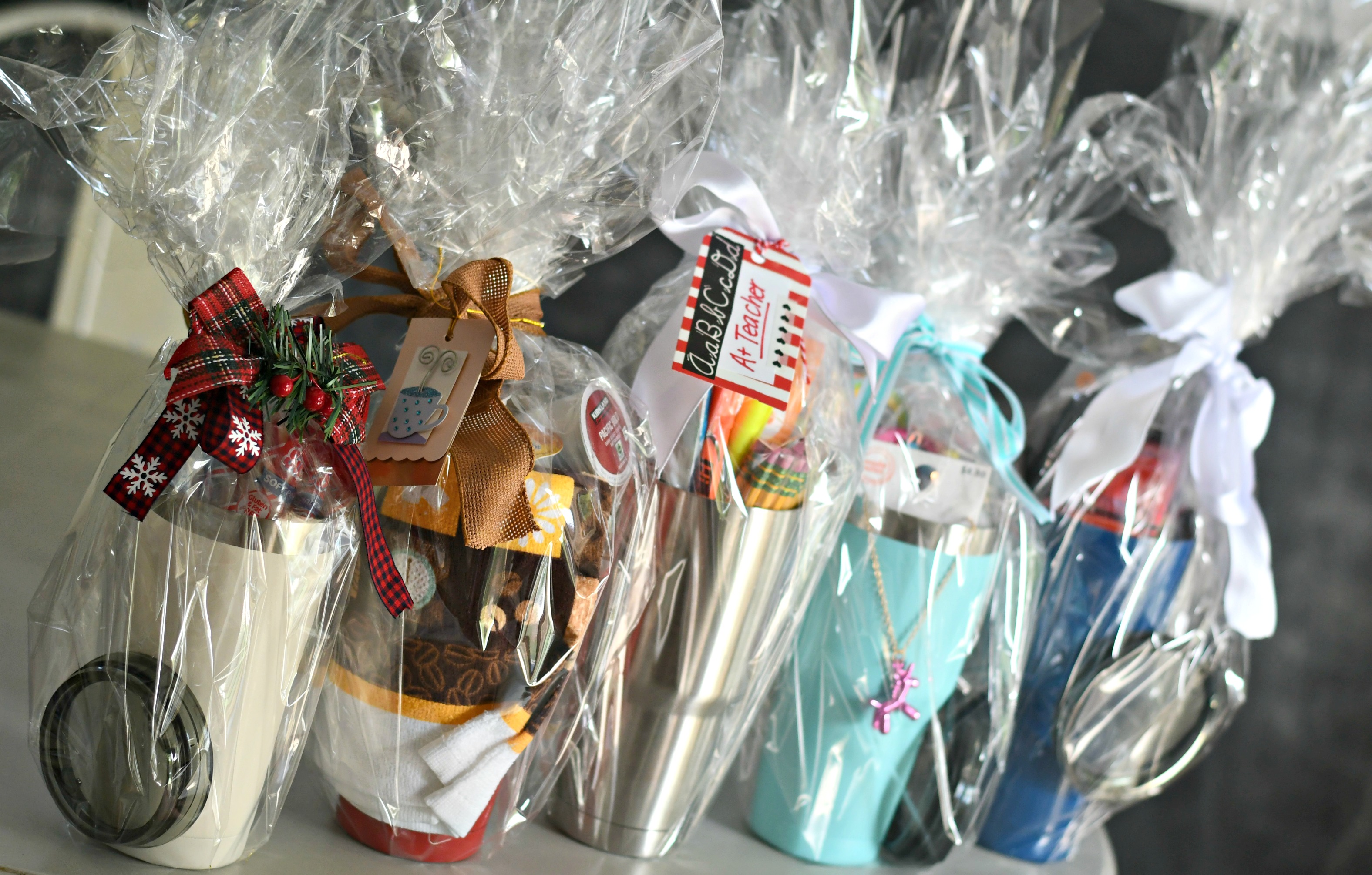 DIY Tumbler Gift basket ideas – tumblers wrapped in cellophane with cards and ribbon