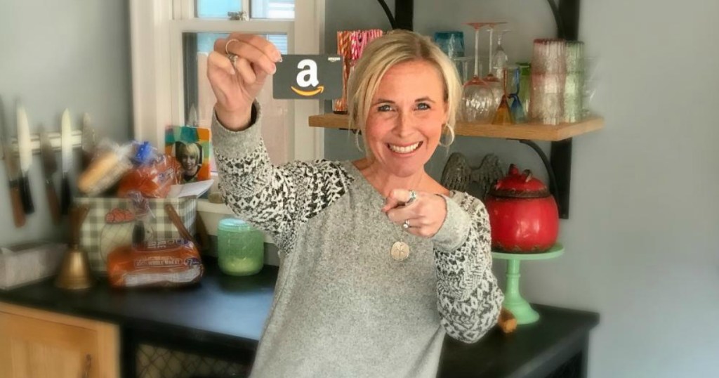woman smiling and holding amazon gift card