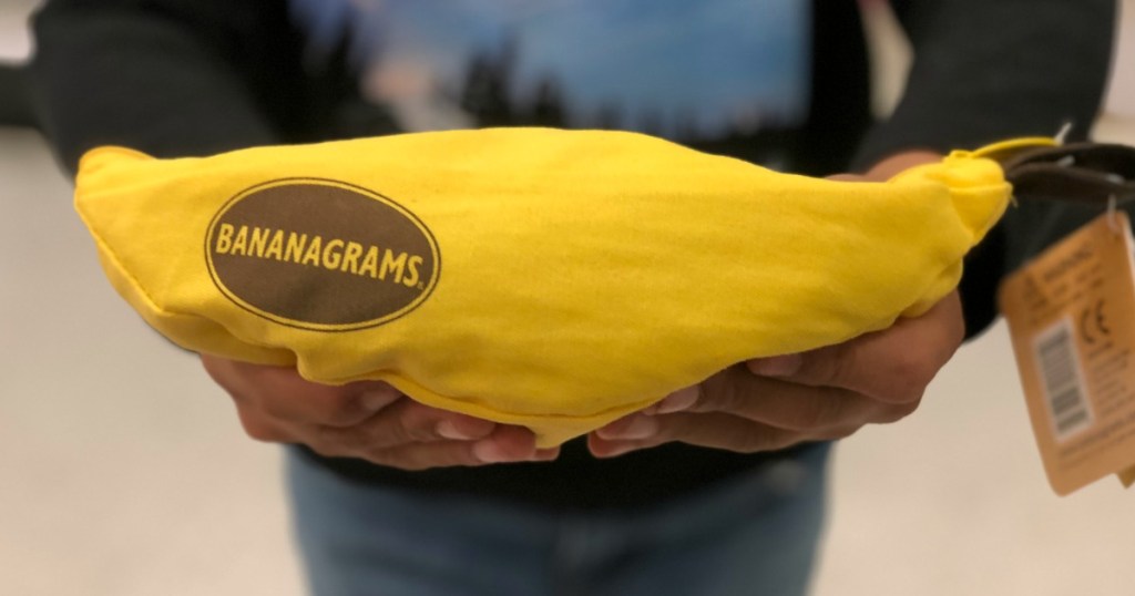 person holding bananagrams game in store