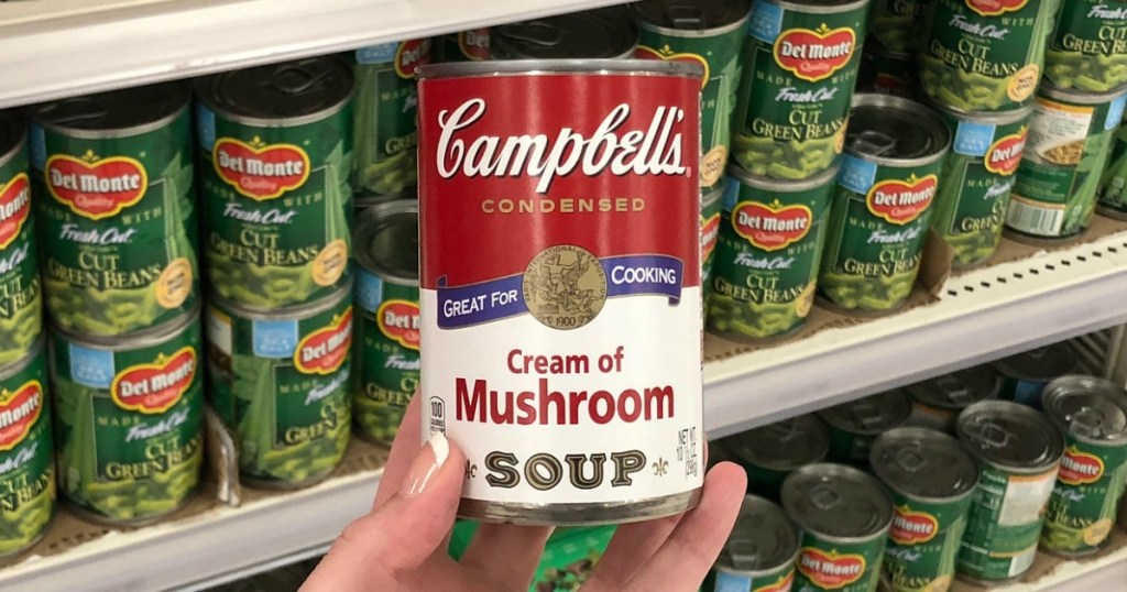 hand holding can of soup 