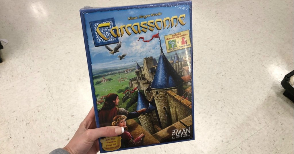 hand holding Carcassonne board game