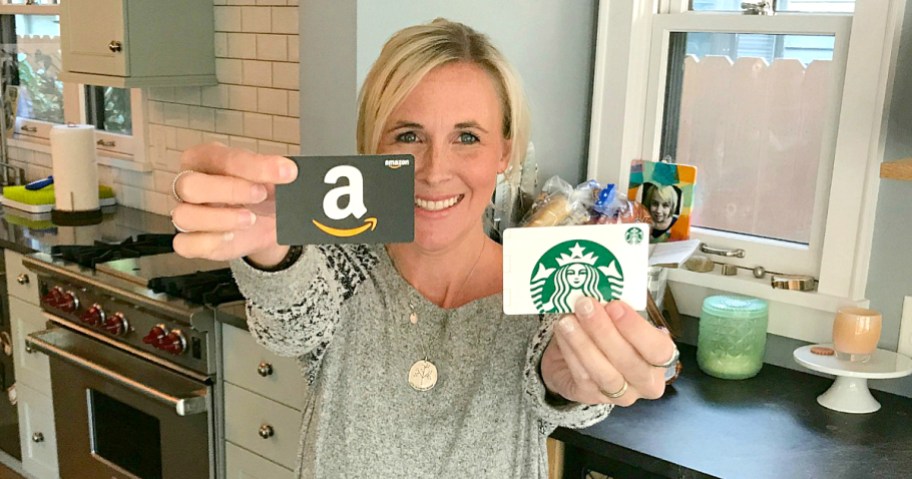 Woman holding up Amazon and Starbucks gift cards