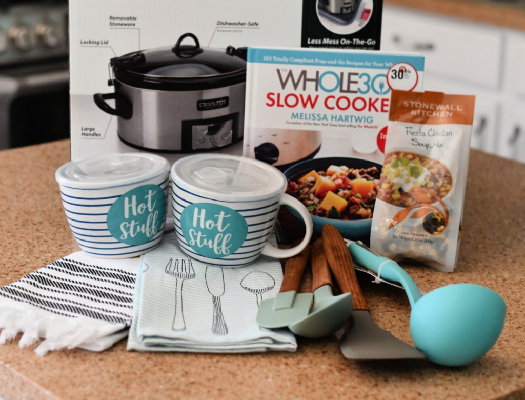 Crockpot gift basket ideas, like small slow cooker gifts, laid out on a countertop