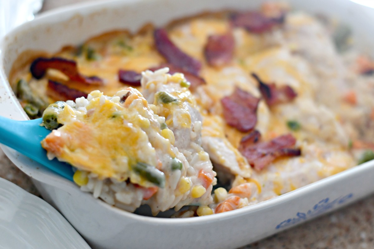 Cheesy Chicken Bacon and Rice Casserole – close up of the finished casserole being served with a spatula