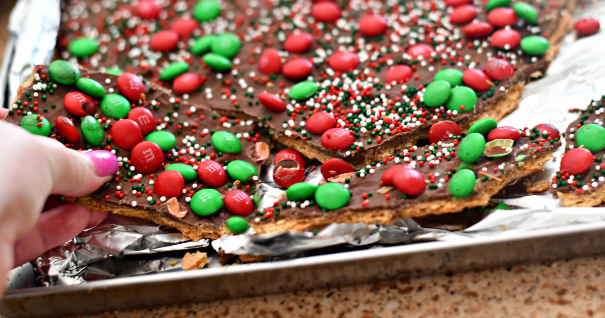 homemade christmas crack toffee – closeup of the toffee being broken apart in the pan