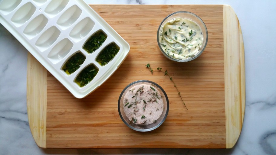 ice cube trays filled with herbs, one of the best food hacks to use in the kitchen