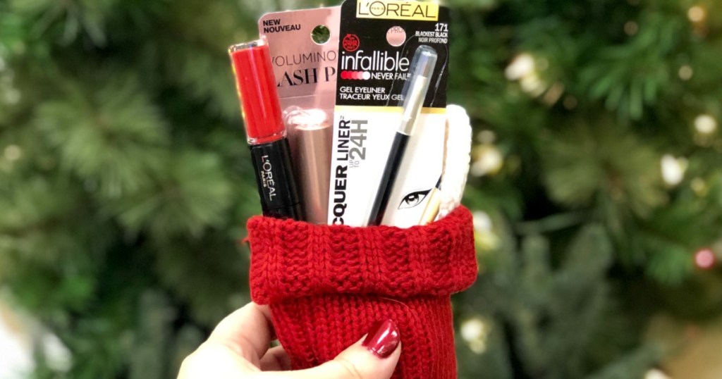 hand holding cosmetics in red stocking