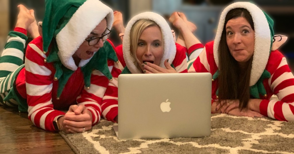 3 woman in elf jammies looking at Macbook screen