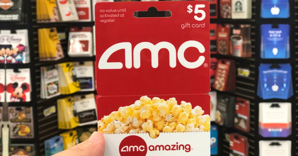 hand holding $5 AMC Theaters Gift Card in front of display