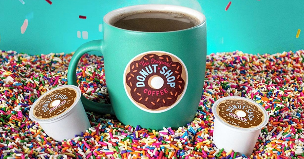 the original donut shop coffee cup and k-cup pods sitting in spinkles
