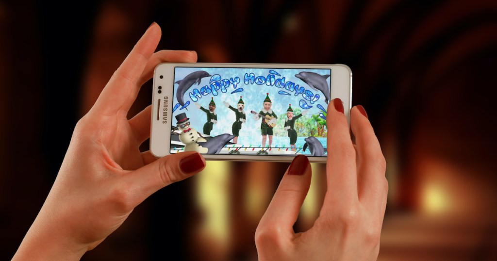 hands holding phone with elf yourself christmas app on screen