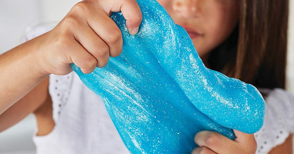 girl holding blue glitter slime