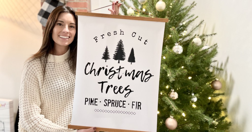 woman holding christmas tree sign - diy home decor projects