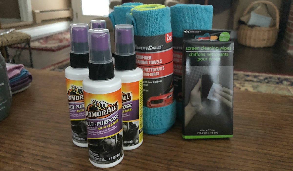 bottles of car cleaner and microfiber towels on table