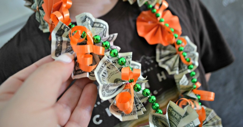person wearing a money lei
