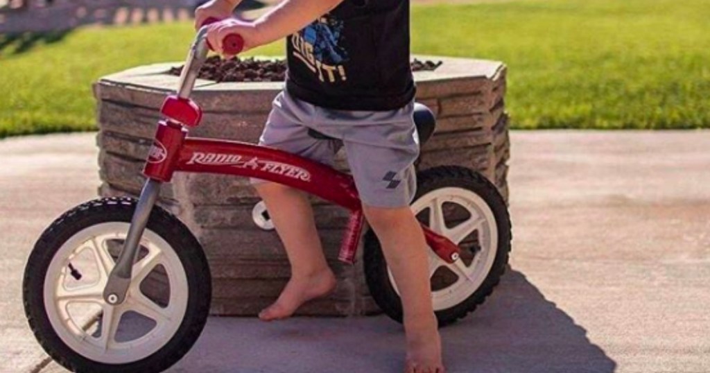 kid riding radio flyer balance bike