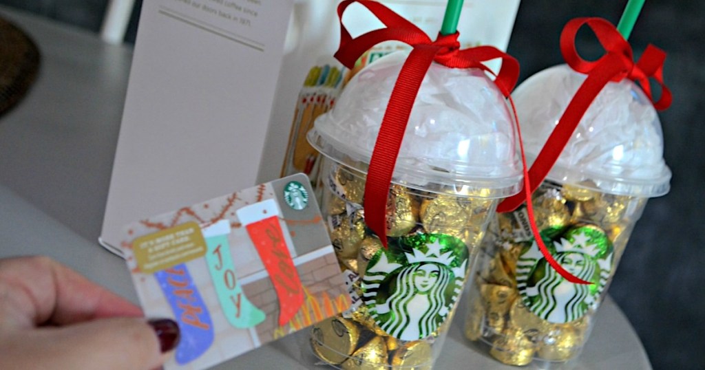 holding Starbucks gift card to put in cup filled with candy