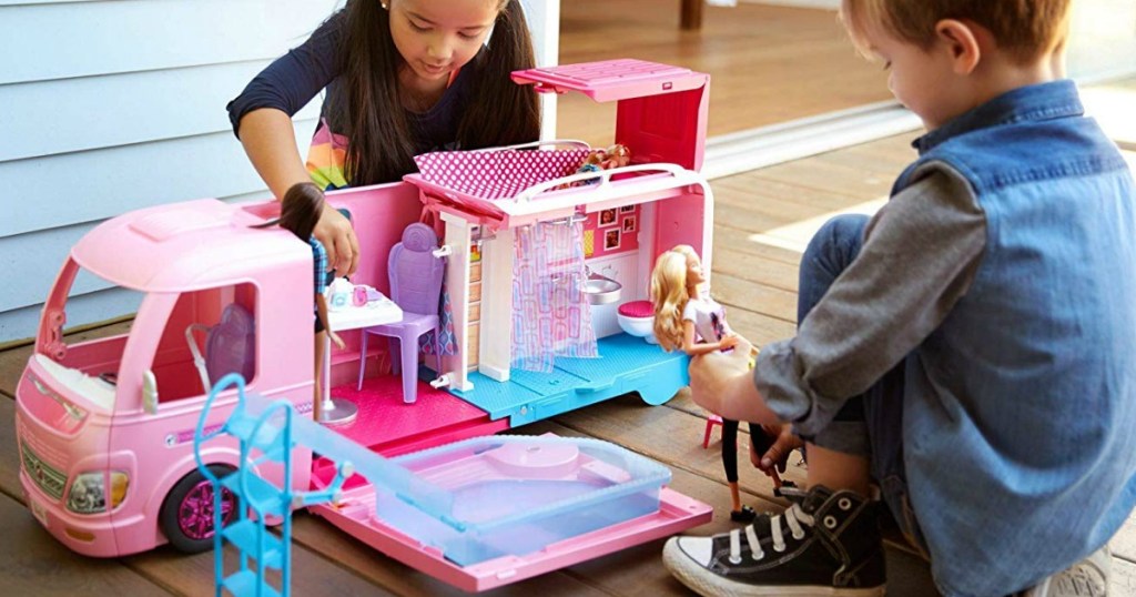 Girl and boy playing with Barbie DreamCamper