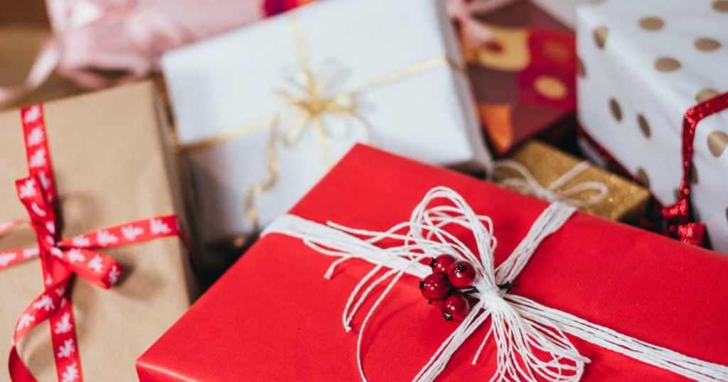 various presents wrapped in red paper and ribbon