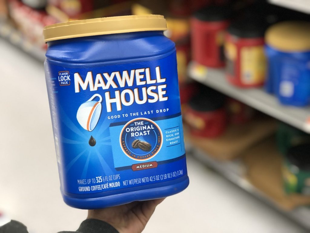 hand holding maxwell house coffee canister in store