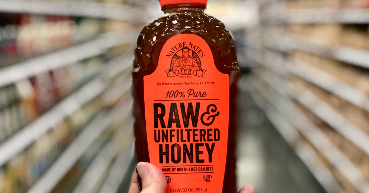 hand holding bottle of honey in store