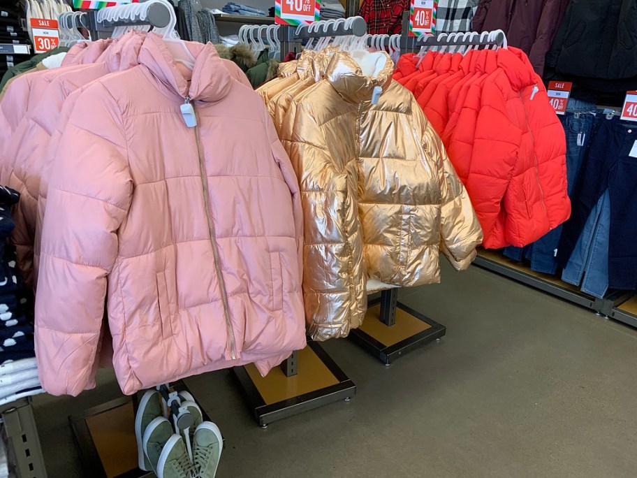 old navy puffer jackets hanging in store