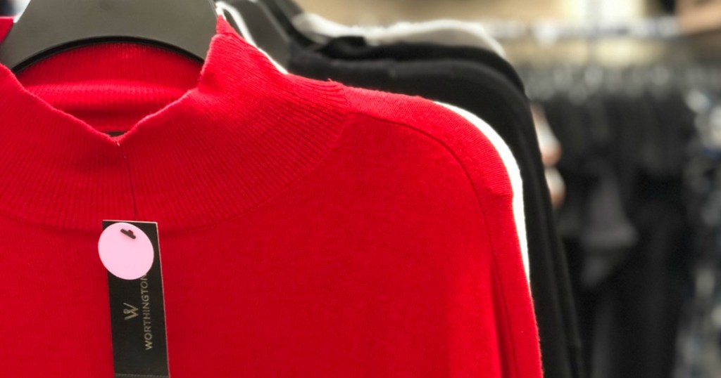 women's sweaters on hangers in a store