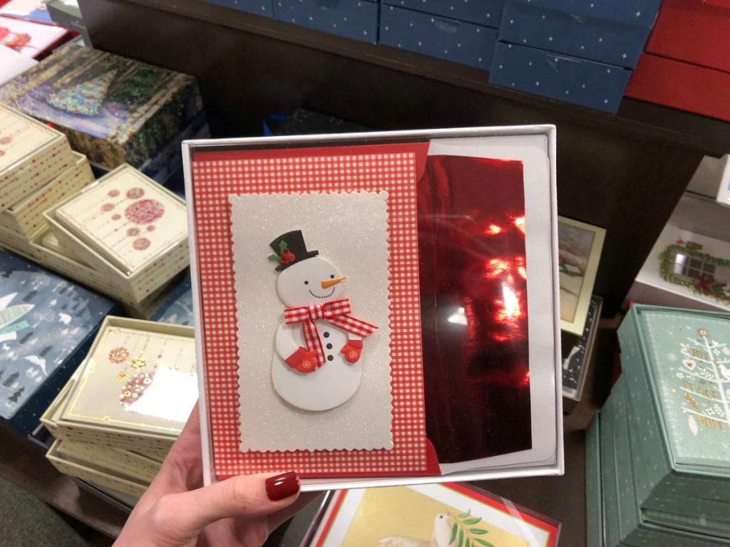 holding a boxed set of christmas cards