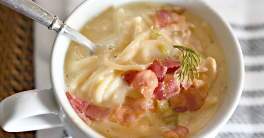 cheesy chicken noodle soup with bacon on top, one of our favorite easy recipes that uses rotisserie chicken