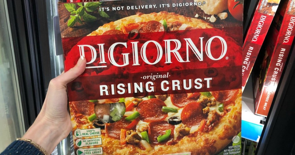 hand holding DiGiorno pizza in cooler 